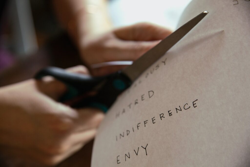 person cutting piece of paper